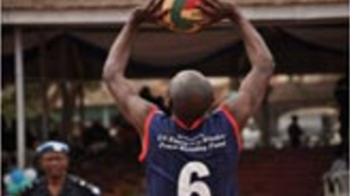 Playing the game, police and military personnel give volleyball their best shot in the qualifying games of the regional tournament.