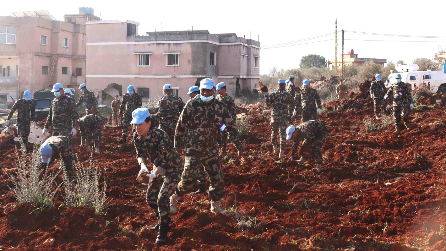 Peacekeepers assist Blida residents to prepare field for olive plantation