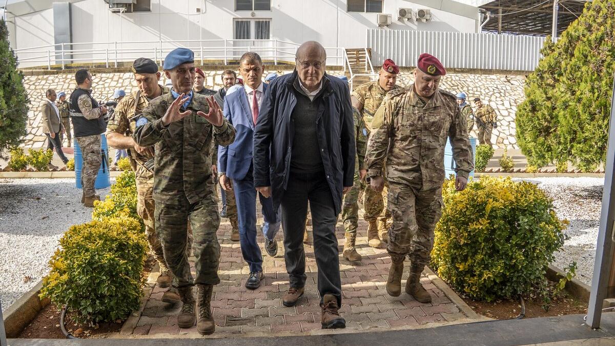 Lieutenant General Aroldo Lázaro and Prime Minister Najib Miqati walk with peacekeepers.